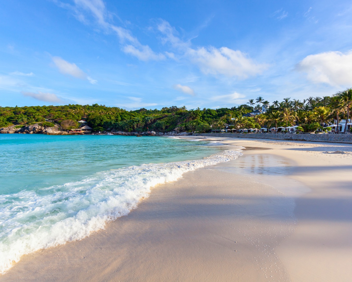 Gentle waves along a sandy beach on Racha Yai Island