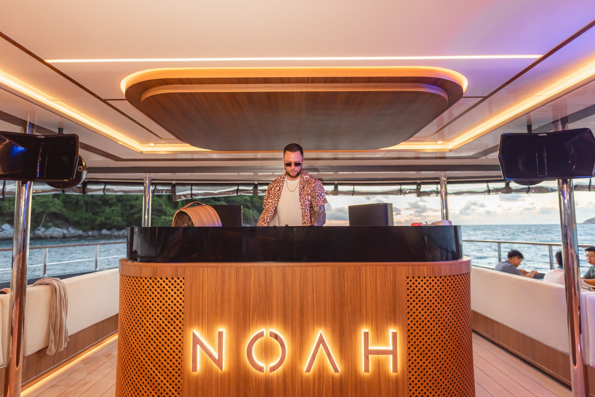 Resident DJ creating a refined beach-club atmosphere on Noah Yacht