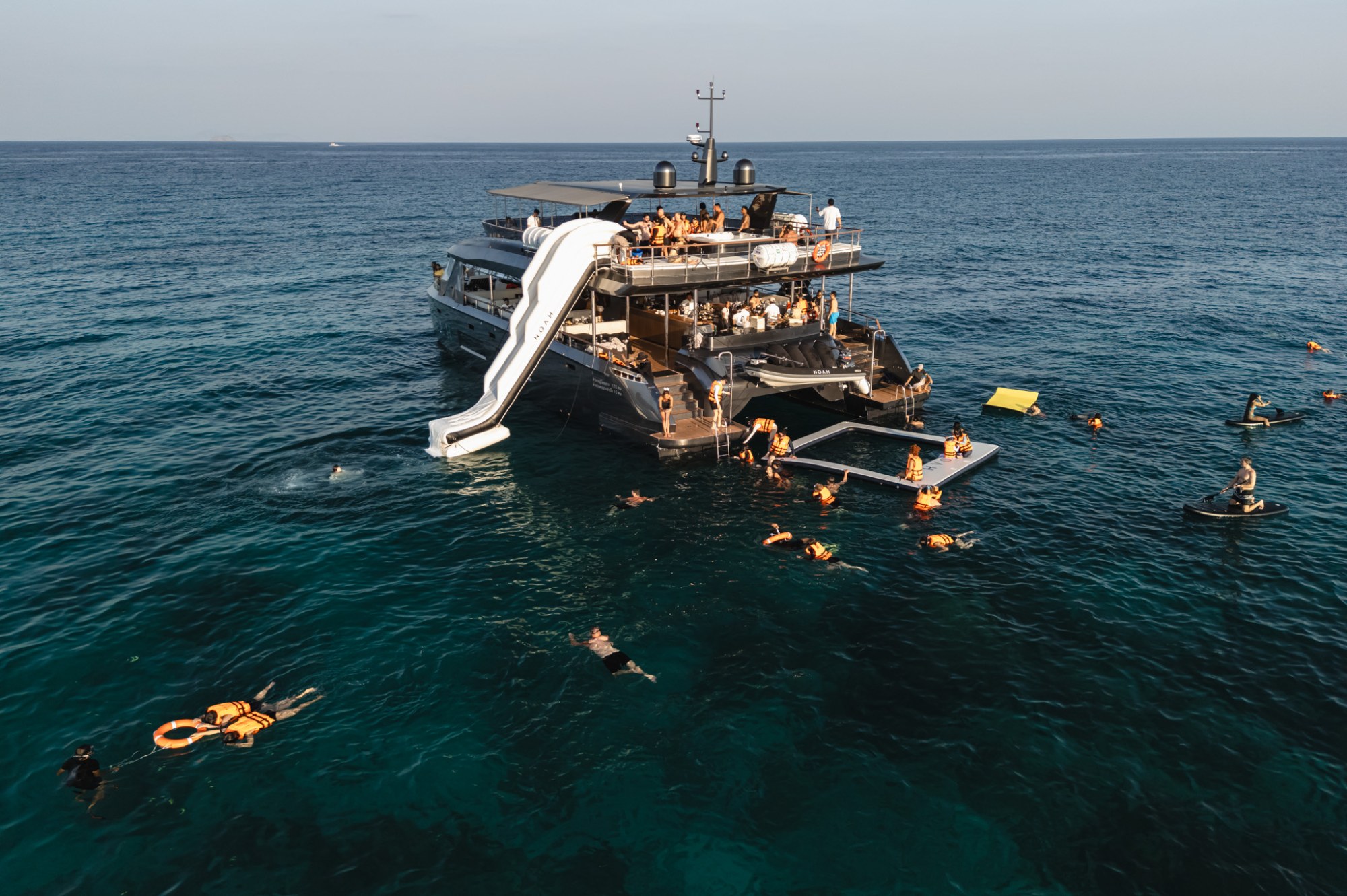 Guests enjoying clear-water snorkelling from Noah luxury yacht