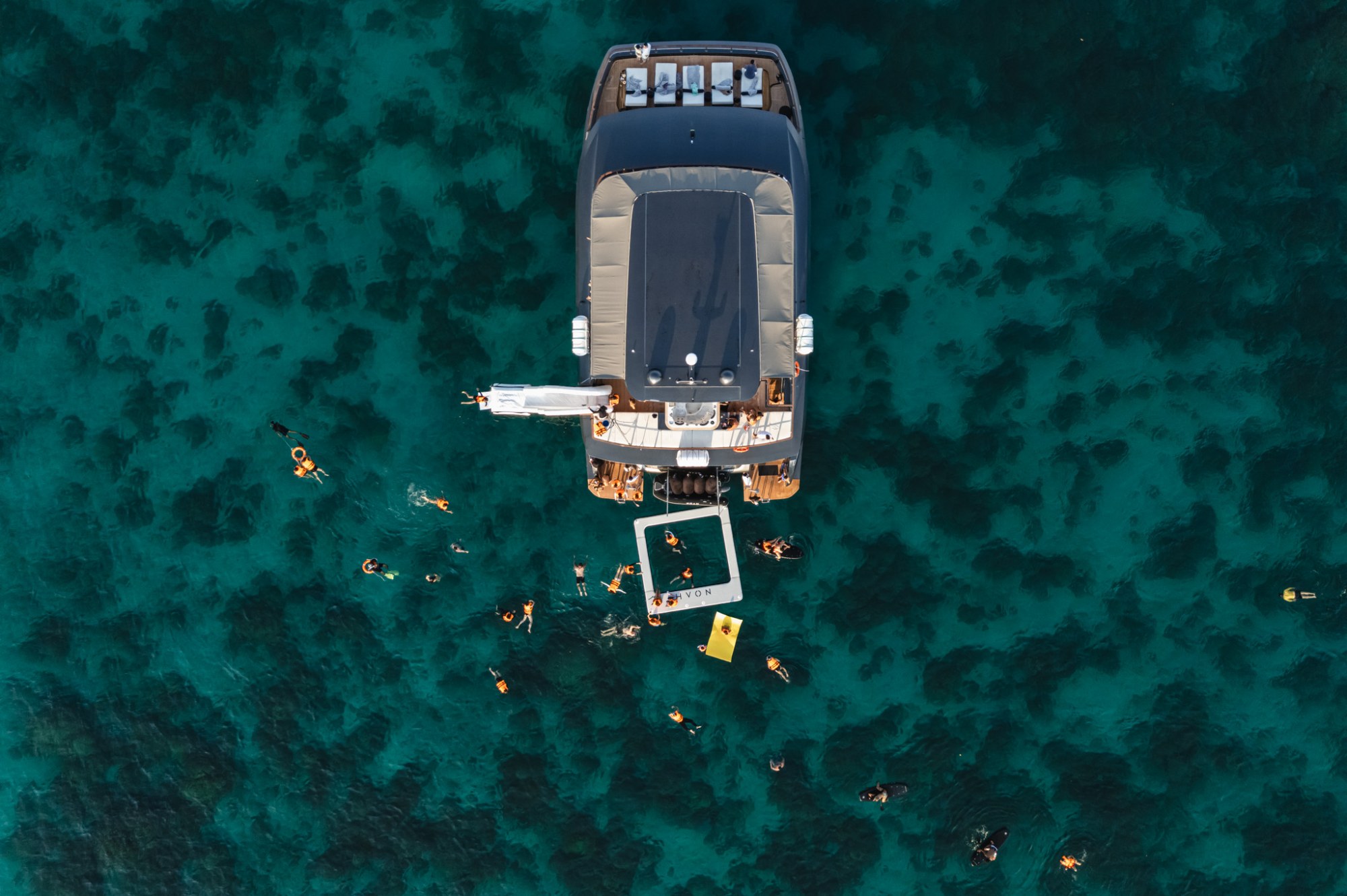 Aerial view of guests snorkelling beside Noah Yacht