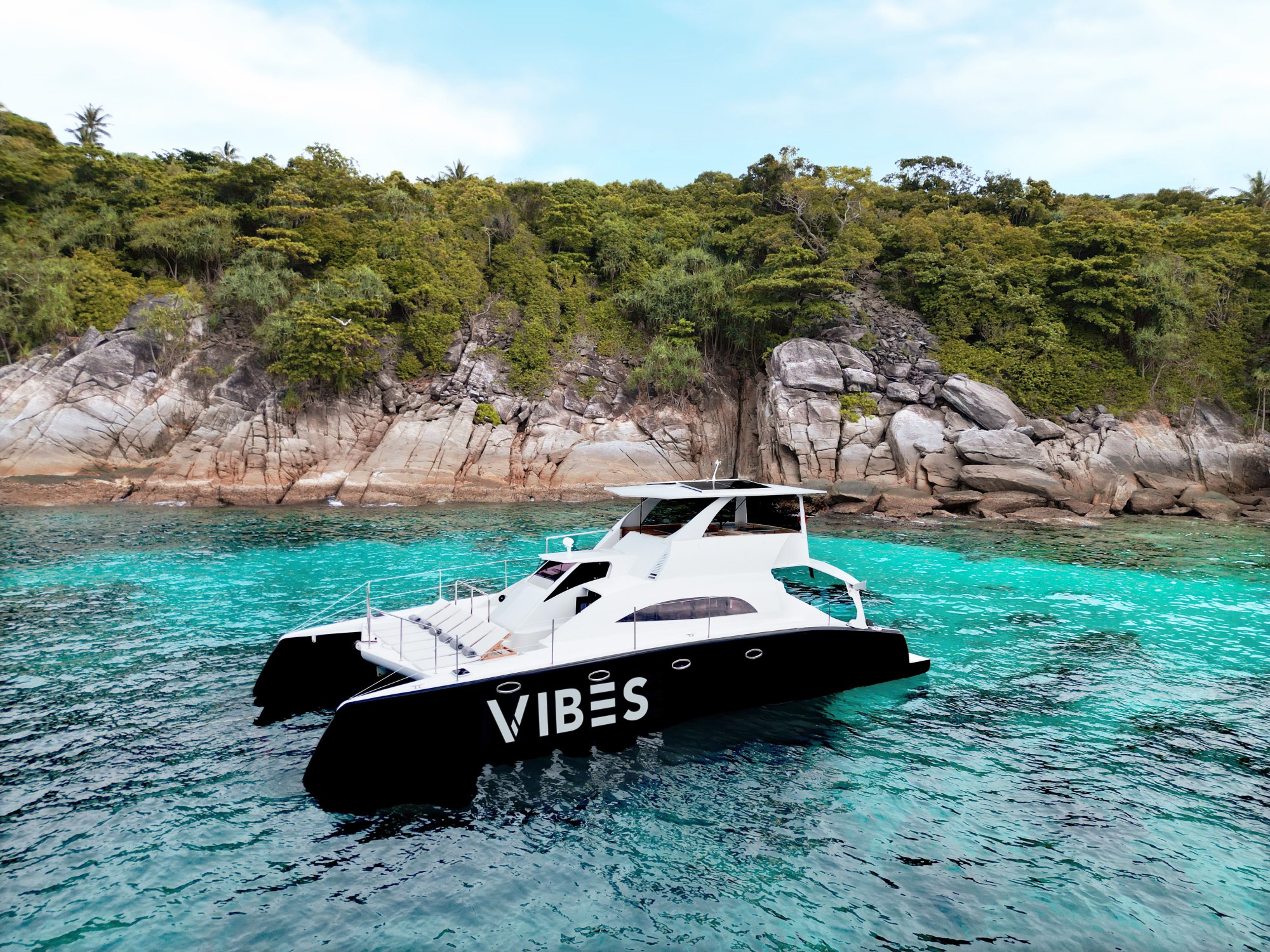 Aerial side view of Vibes Catamaran Yacht at Similan Island