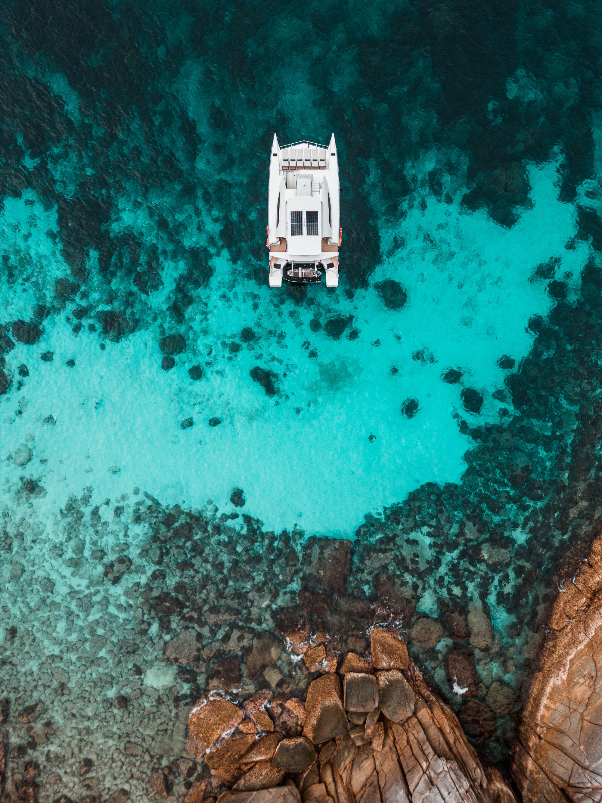 Vibes twin-engine catamaran surrounded by clear Similan water